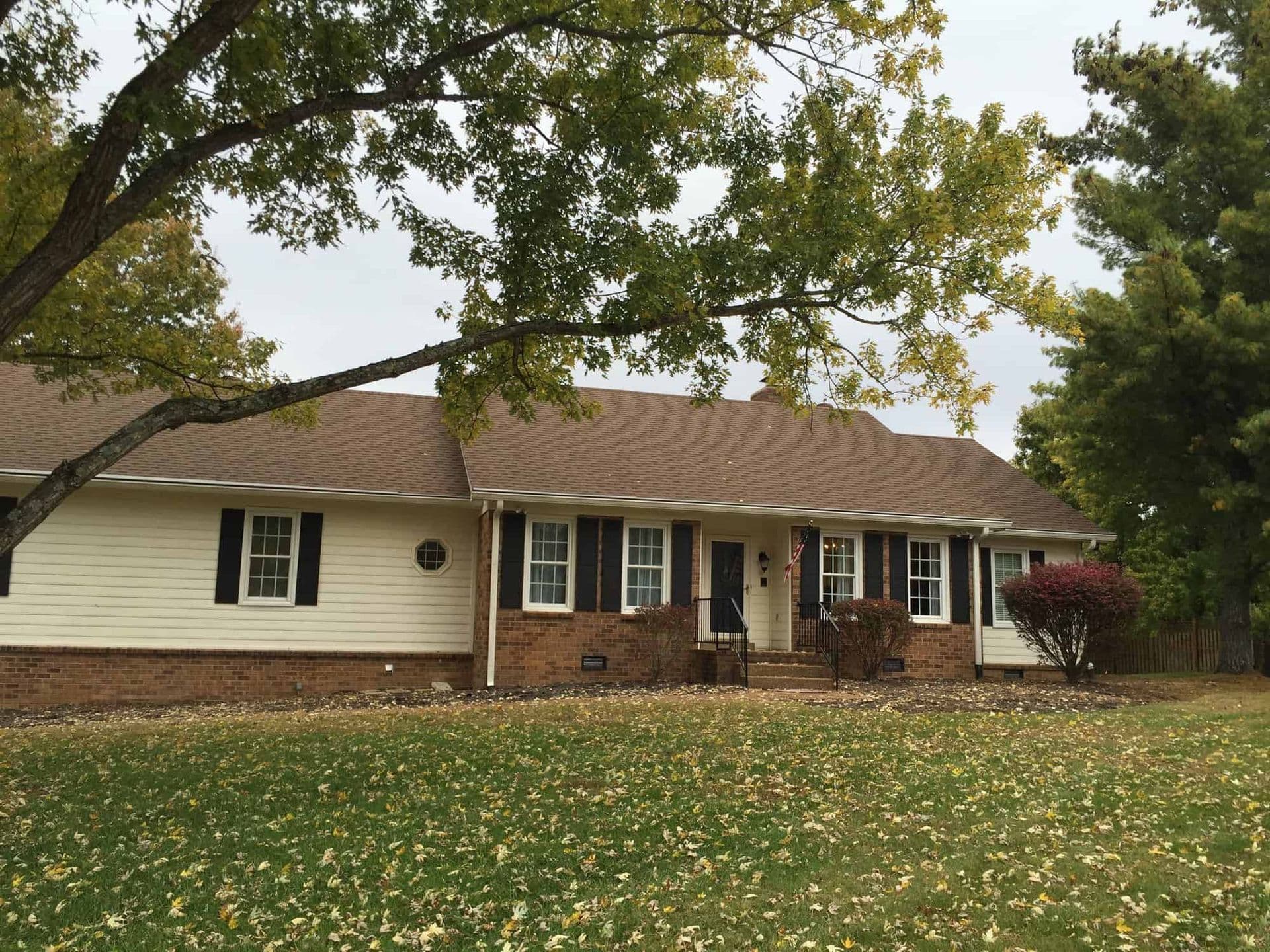 siding-painting-upgrade-cream-on-brick-before